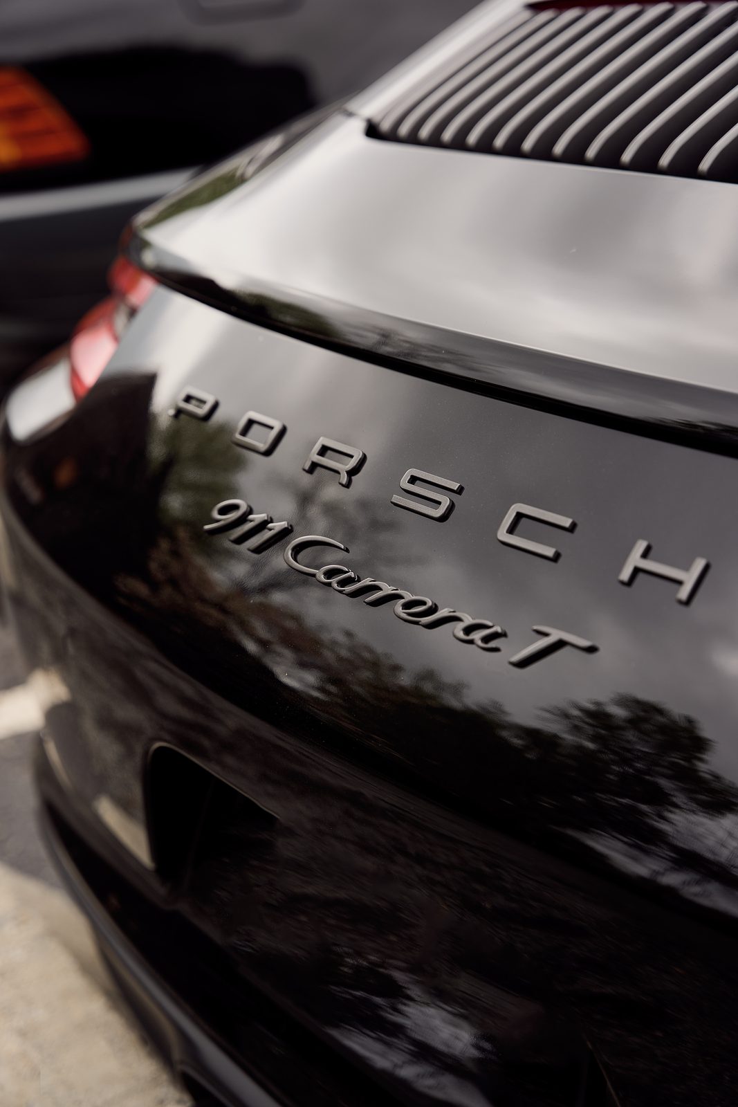 The 911 Carrera T badge on a black Porsche