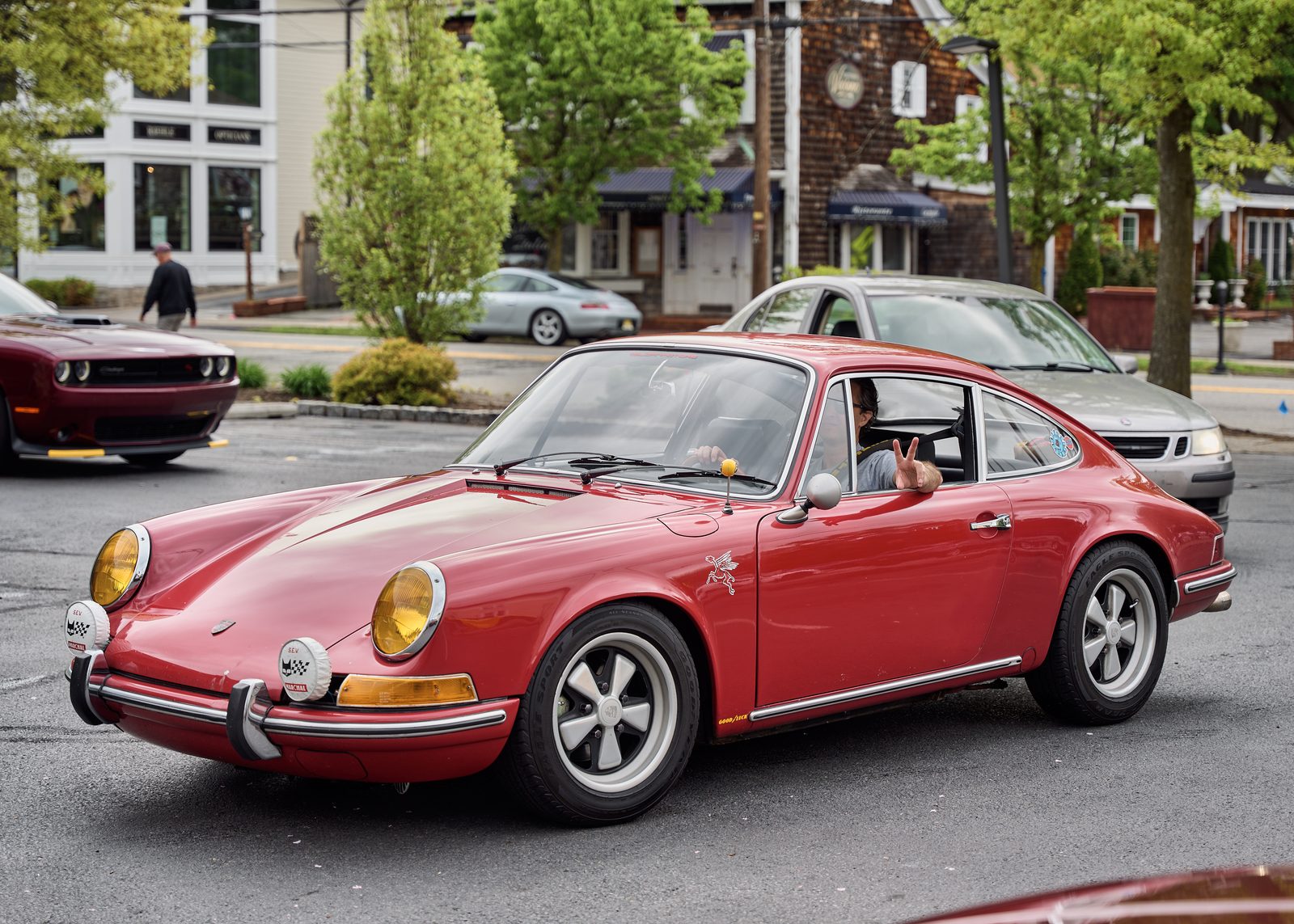 A red classic Porsche 911 in a town car park