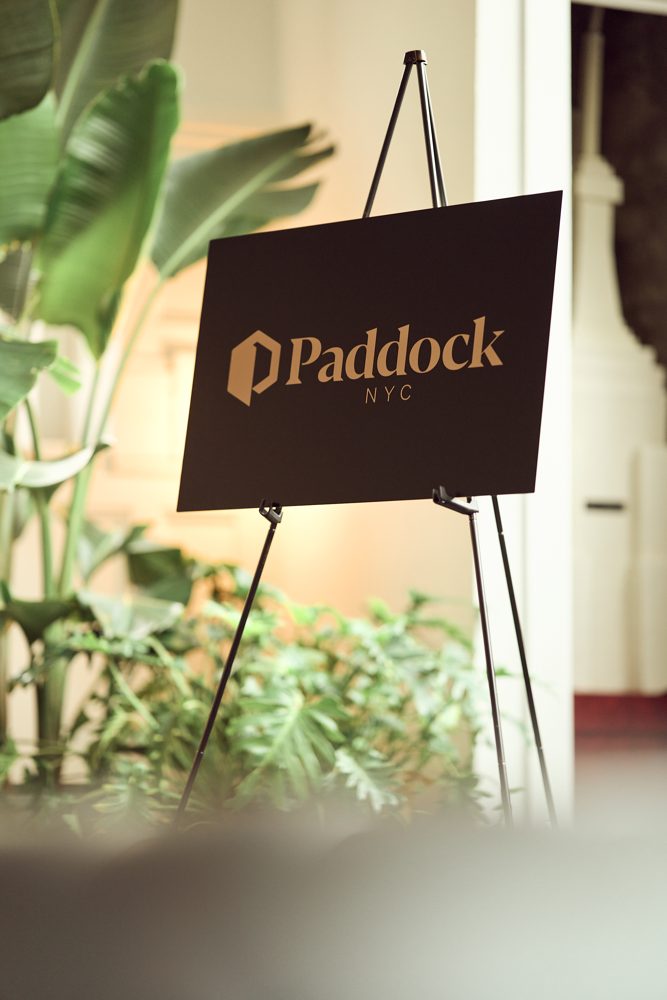 The Paddock sign among plants at the atelier evening